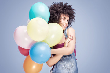 Fototapeta na wymiar Happy african american girl with balloons.