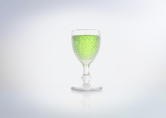Glass of green absinth/absinthe or mint liquor. Isolated on white background.