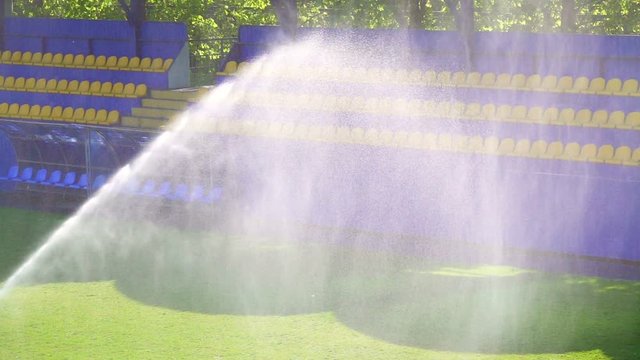 Football field watering, slow motion