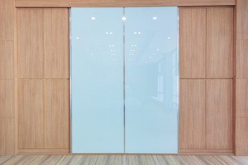 Meeting room with empty room color wall and decorated with wooden floors.