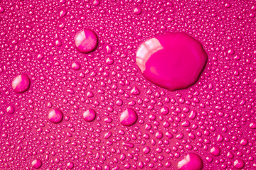 The Abstract water drop on surface of  fresh vibrant pink background