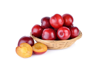 fresh gulf ruby plum in the basket and on white background