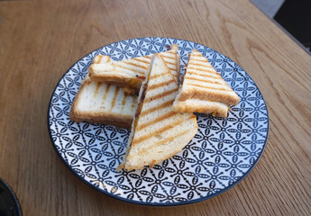 Bacon and cheese toast sandwiches on pattern plate
