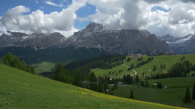 Short pedestal up, panning view of Dolomites near Corvara, Alta Badia, Northern Italy. Prominent peaks include La Varella in the Cunturines subgroup of the Fanes Group.
