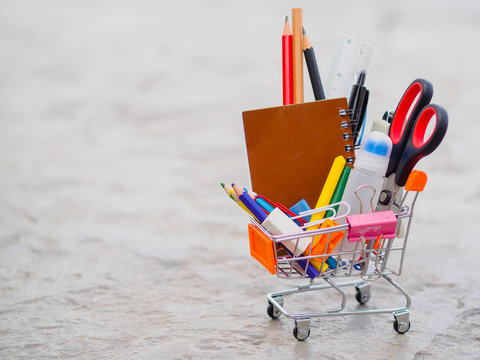 Shopping cart with school supply. Back to school concept.