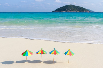 Fototapeta na wymiar Two chairs and umbrella on tropical beach Similan Islands Thailand. Paper, handmade.