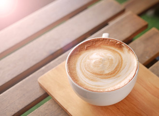 Hot latte coffee coffee on wooden table.