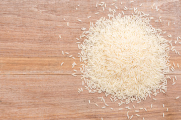 Thai jasmine rice put on wooden plank background