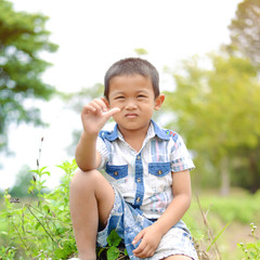 Portrait of young boy in nature, park or outdoors. cute kid outdoor. a child is smiling enjoying adopted life.