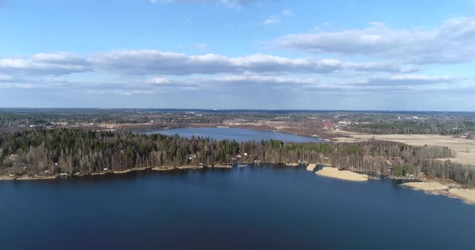 Matalajarvi, Cinema 4k aerial flight above view towards grundtrask above bodom lake, on a sunny spring day, in Espoo, Finland
