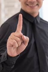 businessman pointing up number 1 finger hand gesture