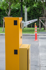 Fototapeta na wymiar Security system for building access - barrier gate stop with toll booth, traffic cones and cctv
