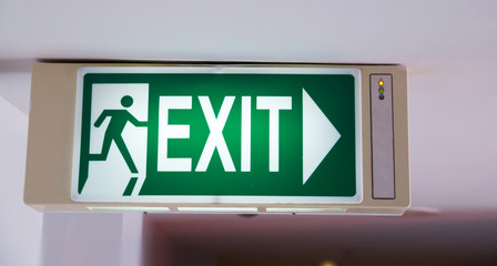 green emergency exit sign in public building (evacuation, exit)