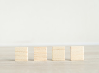 Row of blank wooden blocks on a white