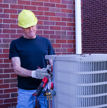 HVAC Technician Repairing Air Conditioning Unit
