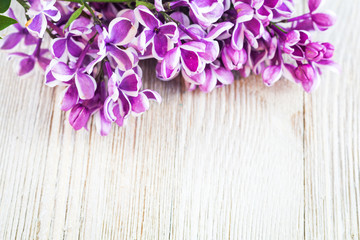 Fresh spring purple lilac on top of wooden board with room for copy