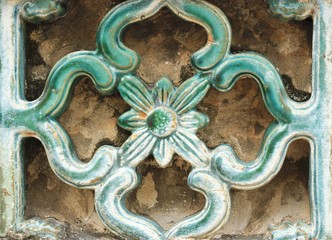 ancient ceramic tiles on the wall of Wat Pho