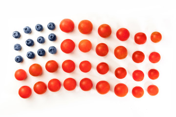 American flag of blueberries and cherry tomatoes on white