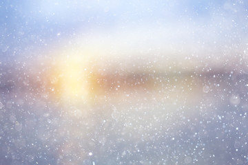 Fototapeta na wymiar Snowfall texture of snowflakes on blurred background