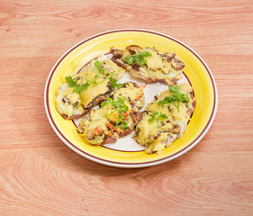Pork chops baked with onion, mushrooms and cheese