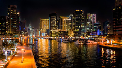 Dubai. In the summer of 2016. Beautiful night lights of ultramodern Dubai Marina on the shores of...
