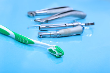 dental care toothbrush with dentist tools on mirror background.