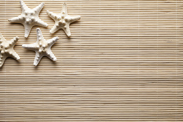 Fototapeta na wymiar Starfishes on wooden background or texture