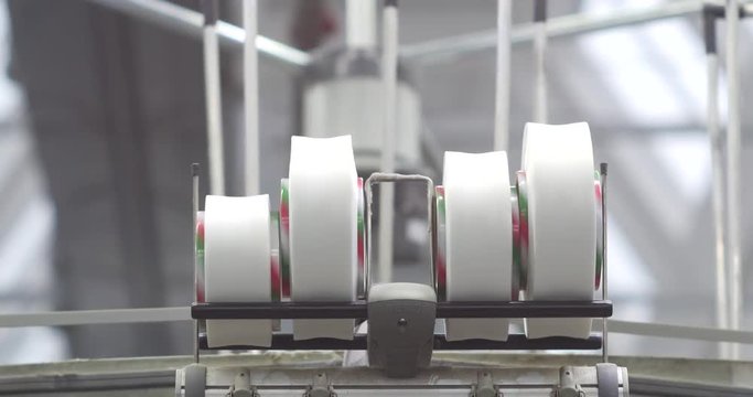 Industrial knitting machine producing cotton yarn