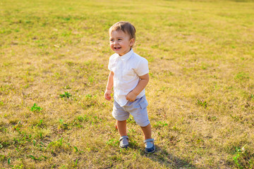 Happy laughing little boy playing in nature