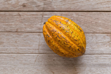 Cocoa fruit on wooden table. green background