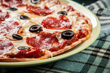 Pizza pepperoni with olives served