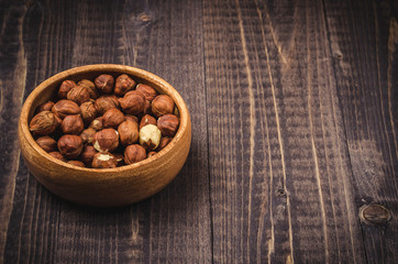 nuts on a wooden dark background/peeled hazelnuts on a wooden background