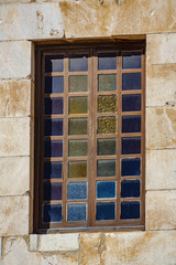 Closeup of colored window and stone wall
