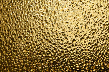 Glass with embossed wave pattern. Glass yellow or gold color.