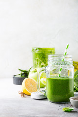 Healthy breakfast with green smoothie in glass jar and ingredients. Detox, diet, healthy, vegetarian food concept with copy space.