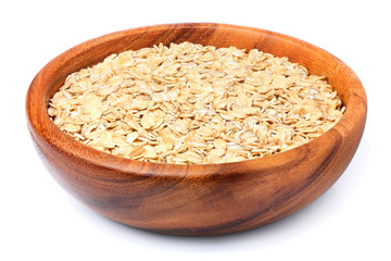 Oat flakes in a wooden plate.