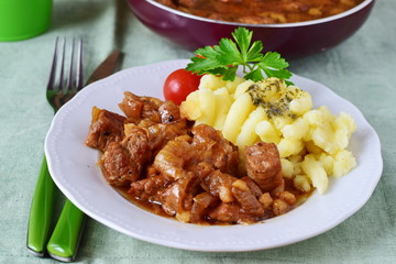 Pork fried with onions on a plate with mashed potato. Home cooking
