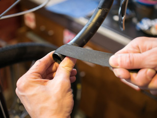 Man reeling tape on bicycle