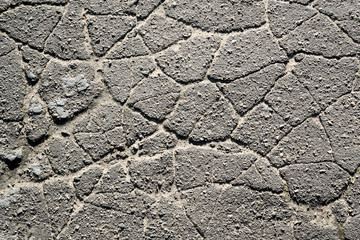 Texture of old cracked asphalt in the daytime
