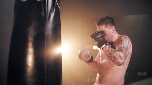 Determinated man training punch exercises 