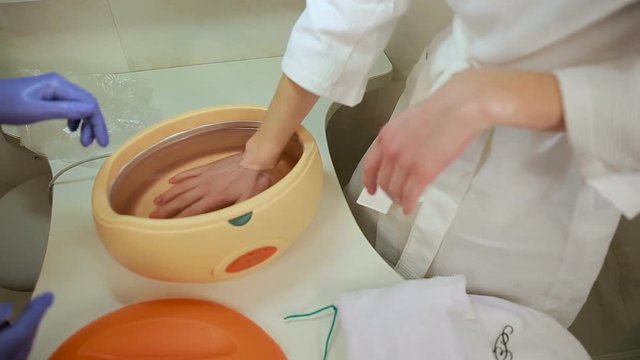Paraffin therapy for hands in cosmetic clinic