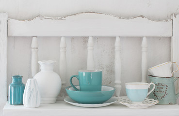 Fototapeta na wymiar dinnerware on white wooden shelf