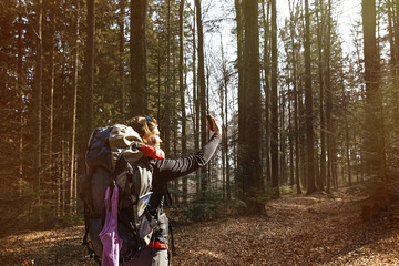 Fototapeta premium Woman taking a selfie on a hike through the woods
