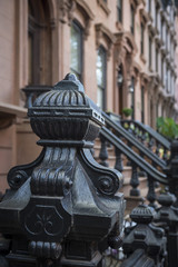 A neighborhood block in brownstone Brooklyn features decorative finishes on rows of front stoop...