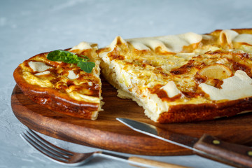 Sliced homemade tart with leek and cheese. French quiche.