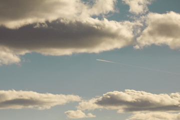 Naklejka na ściany i meble Airplane trails in cloudy sky