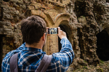 Fototapeta na wymiar tourist taking picture of ruins