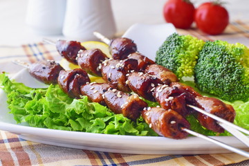 Oven cooked chicken hearts on sticks with vegetables. Healthy food
