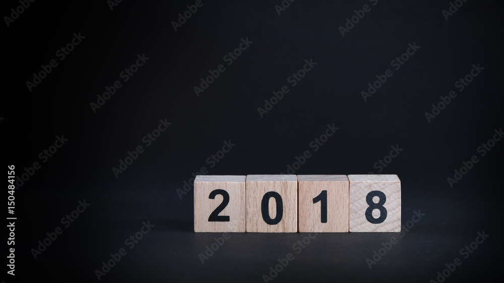 Wall mural Wooden cube number 2018 on black background, happy new year concept and holiday and event idea