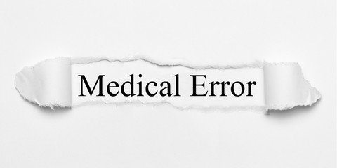 Medical Error on white torn paper